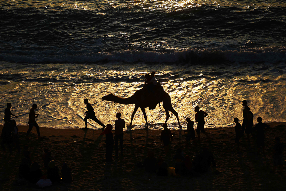 Palestinians spend time at the beach at sunset in Gaza City. PHOTO: AFP