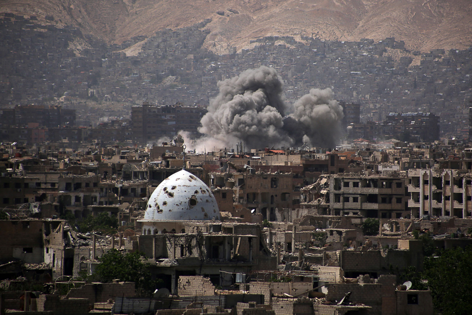 A general view shows smoke rising from buildings following an air strike on Jobar, a rebel-held district on the eastern outskirts of the Syrian capital Damascus. PHOTO: AFP