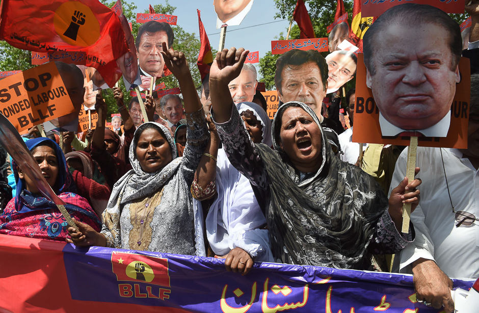 Pakistani workers carry cutouts of images of Pakistani political parties leaders as they shout slogans during a May Day rally to mark International Labour Day in Lahore. PHOTO: AFP