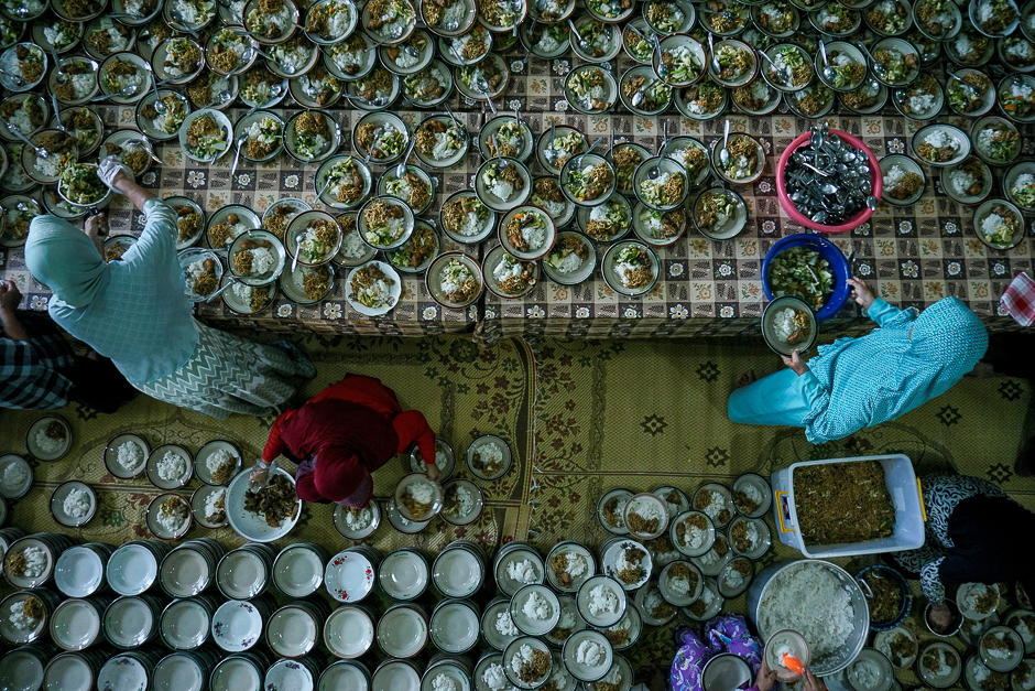 People prepare food for breaking fast on the first day of Ramadan at a mosque in Yogyakarta, in Java, Indonesia. PHOTO: REUTERS