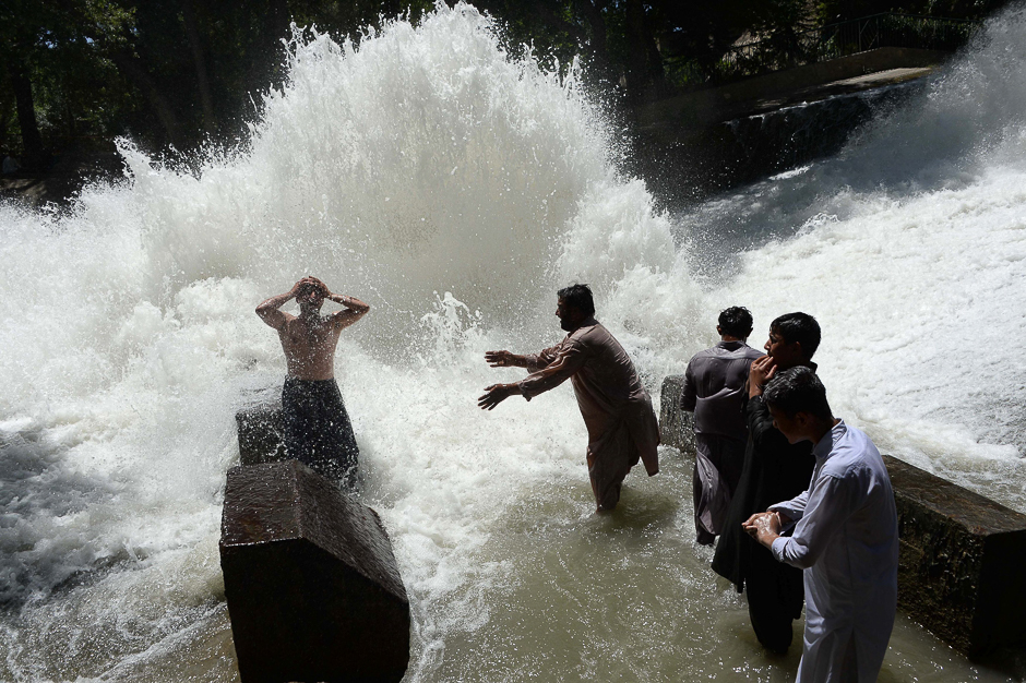 Afghan youths cool off on a hot day as temperatures reached around 43 degrees Celsius (109 degrees Fahrenheit) on the first day of the Islamic holy month of Ramadan on the outskirts of Jalalabad. PHOTO: AFP