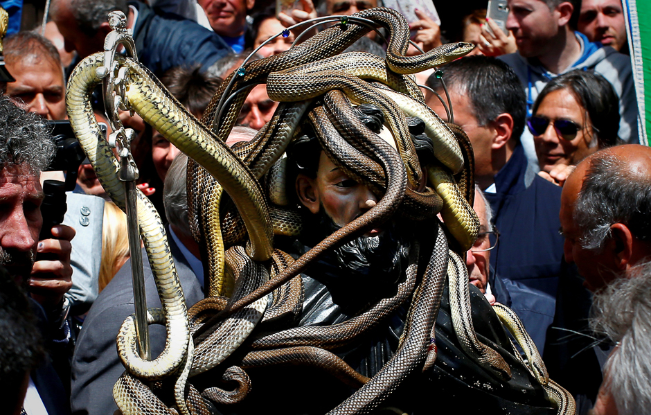 Snakes cover a wooden statue of Saint Domenico during a procession in Cocullo, central Italy. PHOTO: REUTERS
