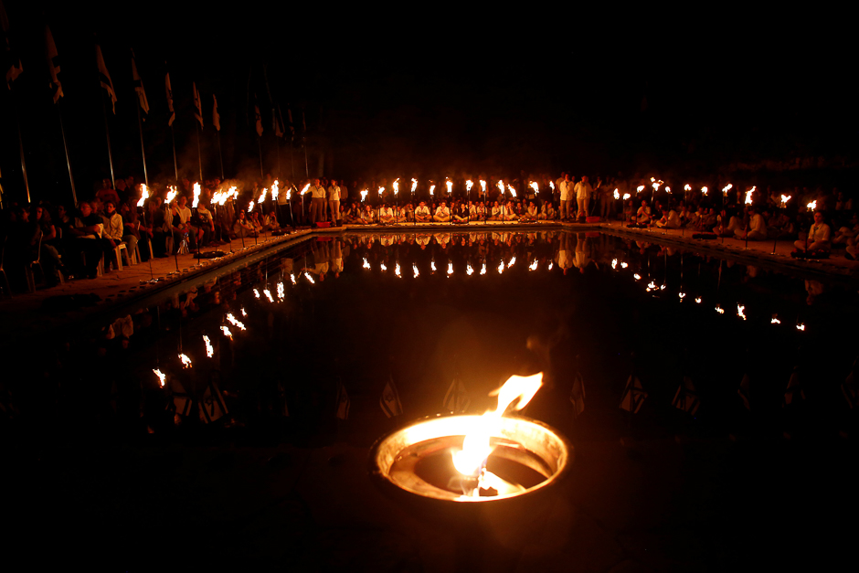 Israeli scouts hold a torch during a ceremony marking Memorial Day at the Mount Herzl military cemetery in Jerusalem. PHOTO: REUTERS