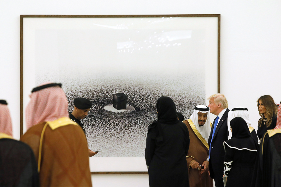 Saudi Arabia's King Salman bin Abdulaziz Al Saud (3rd R) shows US. President Donald Trump (2nd R) and first lady Melania Trump (R) a depiction of the Kaaba in Mecca titled 'Magnetism' by artist Ahmed Mater, during a tour of pieces in the King's art collection at the Royal Court in Riyadh, Saudi Arabia. PHOTO: REUTERS