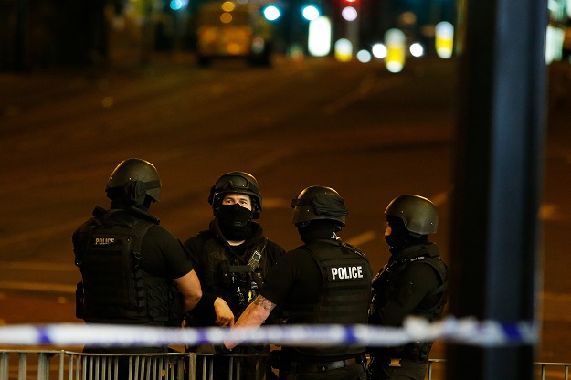 Armed police officers stand near the Manchester Arena, where U.S. singer Ariana Grande had been performing, in Manchester, northern England, Britain May 23, 2017. PHOTO: REUTERS