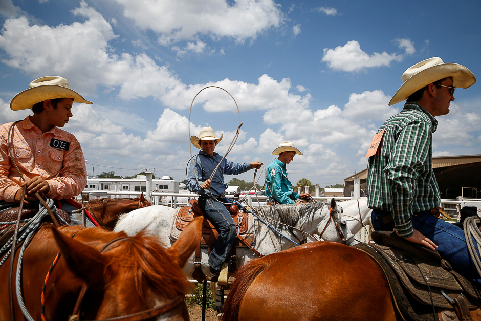 Calf-roping competitors (L-R) Cody Vina, Cayden Newsome, Clayton Culligan and Blake Crawford wait their turns during the 