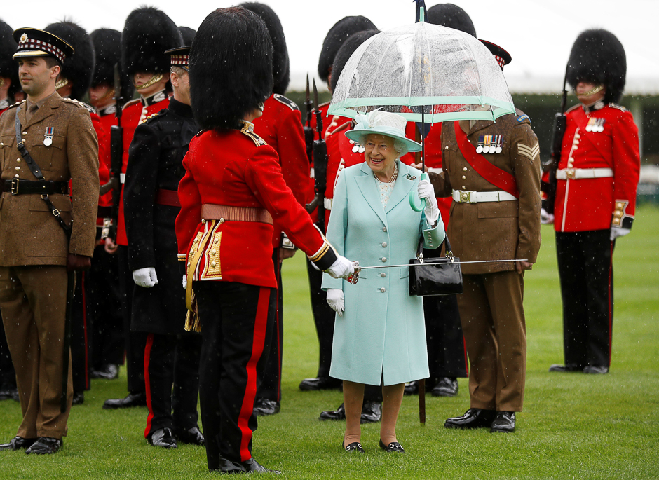 Britain's Queen Elizabeth presents members of the Scots Guards with new colours at a ceremony at Buckingham Palace in London. PHOTO: REUTERS