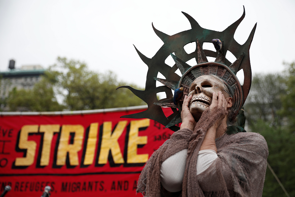 A woman wearing a costume stands during a May Day protest in New York, US. PHOTO: REUTERS