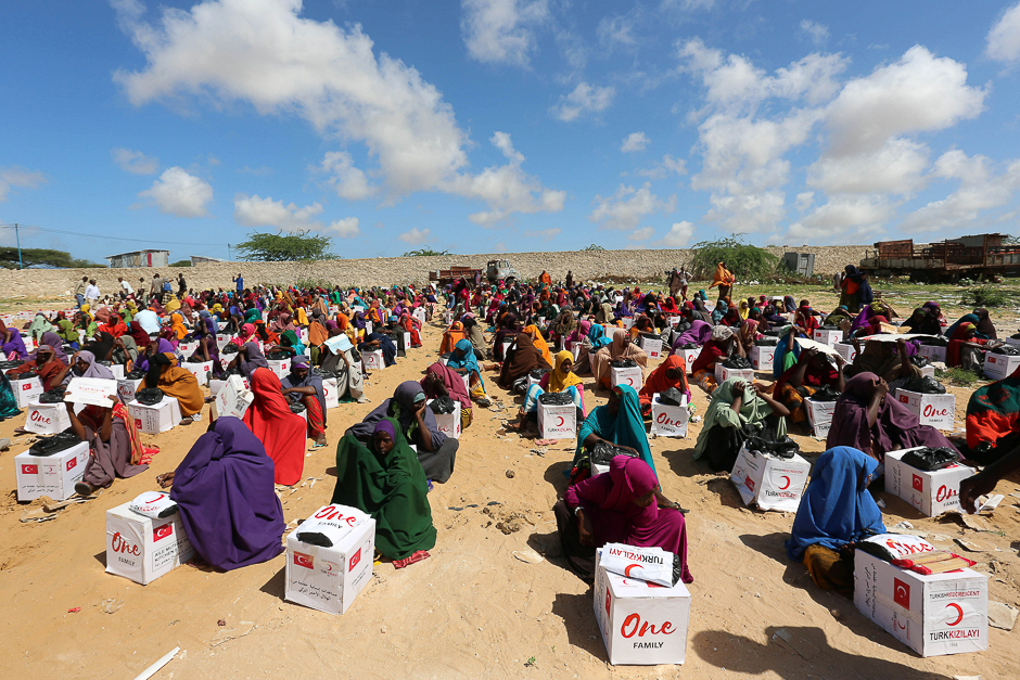 Displaced Somalis sit after receiving boxes of food distributed by the Turkish Red crescent in a camp in Mogadishu, Somalia. PHOTO: REUTERS