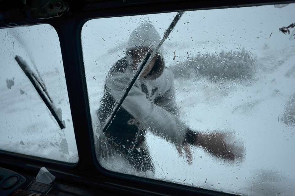 A driver cleans a windshield of his track during heavy snow storm as he carries building materials to the Bilyi Slon, White Elephant, the highest inhabited building in Ukraine and an old astronomical observatory, near the village of Vorokhta. PHOTO: AFP