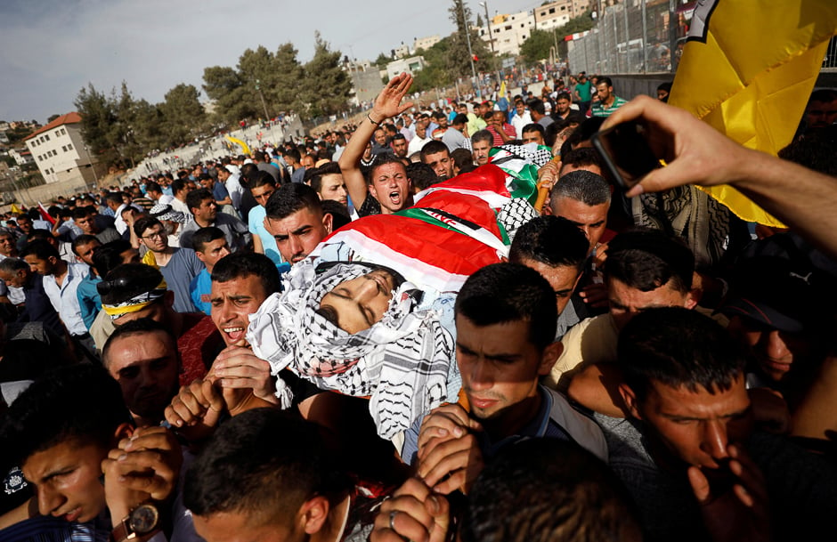 Mourners carry the body of Palestinian Motaz Bani Shamsa during his funeral in the West Bank village of Beita, near Nablus. PHOTO: REUTERS