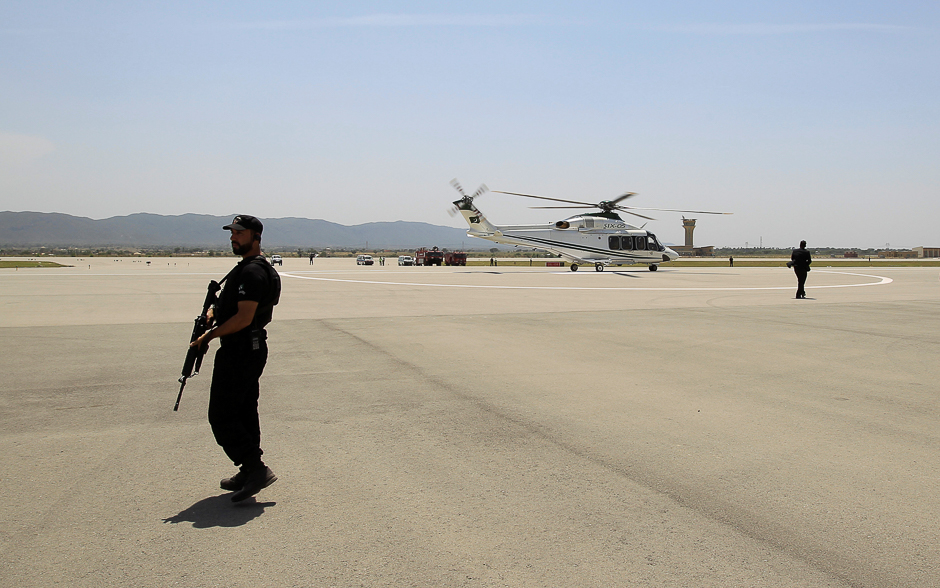 Security personnel stand guard as the helicopter carrying Pakistani Prime Minister Nawaz Sharif lands at the newly built airport in Islamabad. PHOTO: REUTERS