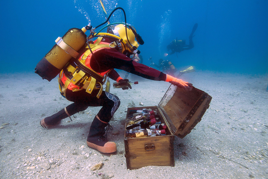 A diver takes wine bottles from an underwater trunk in the Mediterranean Sea off Saint-Mandrier, southern France. Bandol wine matured undersea during one year before being analysed. PHOTO: AFP