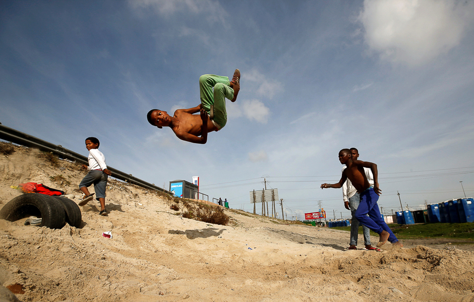 Youths somersault over old tyres in the Khayelitsha township, near Cape Town, South Africa. PHOTO: REUTERS