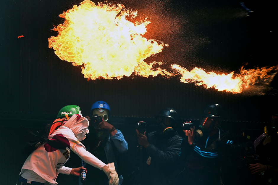 An opposition activist throws a Molotov cocktail during a march against President Nicolas Maduro, in Caracas. PHOTO: AFP