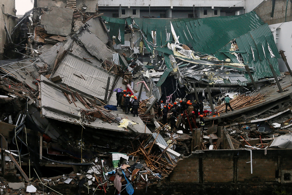 Military officials and fire brigade members work during a rescue mission after a building collapsed in Colombo, Sri Lanka. PHOTO: REUTERS