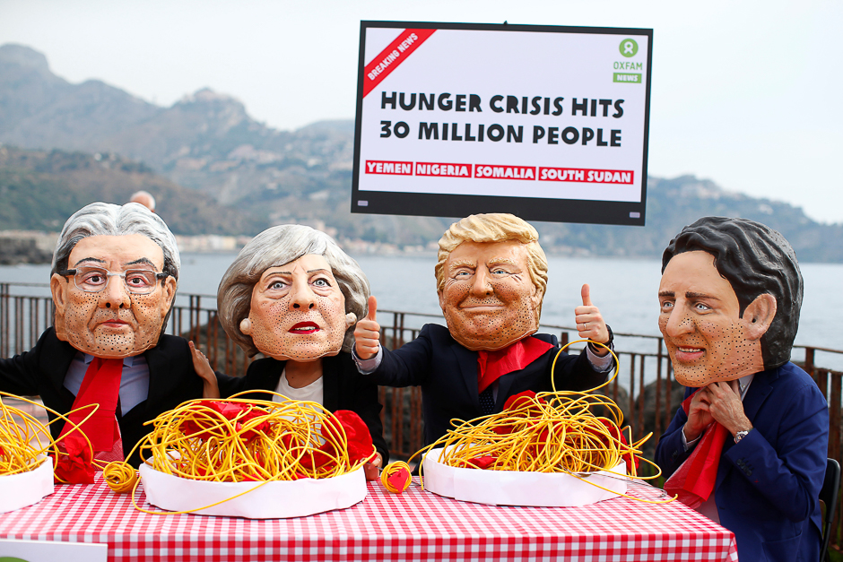 Protestors wear masks depicting the leaders of the G7 countries during a demonstration organised by Oxfam in Giardini Naxos, Sicily, Italy. PHOTO: REUTERS