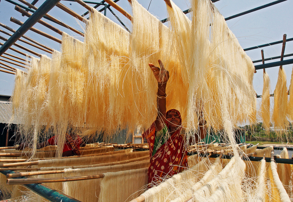 A woman arranges strands of vermicelli, a specialty eaten during the Muslim holy fasting month of Ramadan, which are kept out to dry at a factory in Agartala, India. PHOTO: REUTERS