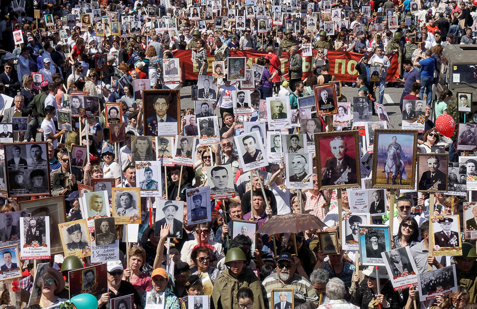 People carrying portraits of deceased relatives who took part in World War Two, march in a parade during Victory Day commemorations in Almaty, Kazakhstan. PHOTO: REUTERS
