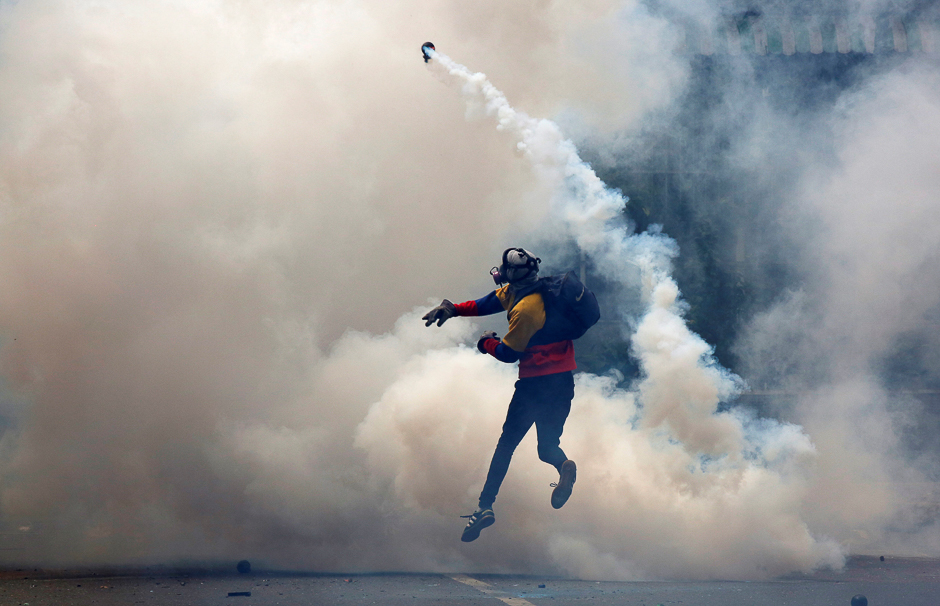 An opposition supporter clashes with riot police during a rally against President Nicolas Maduro in Caracas, Venezuela. PHOTO: REUTERS