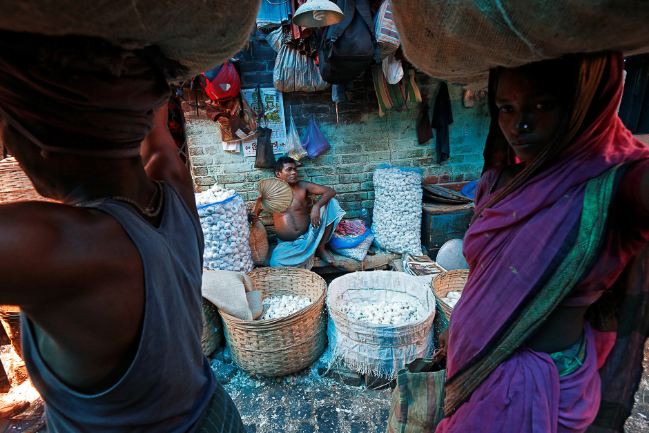 A vendor fans himself as he waits for customers at a wholesale vegetable market on a hot summer day in Kolkata, India. PHOTO: REUTERS