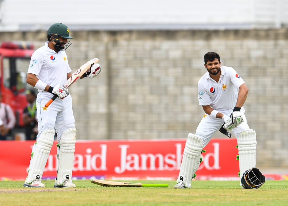 Azhar Ali of Pakistan celebrates his century as Misbah ul Haq cheer him during the 3rd day of the 2nd Test match between West Indies and Pakistan at Kensington Oval, Bridgetown, Barbados. PHOTO: AFP