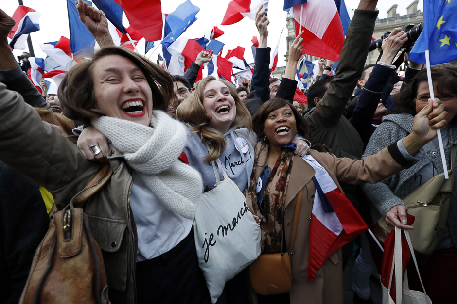 Supporters of French presidential election candidate for the En Marche ! movement Emmanuel Macron celebrate in front of the Pyramid at the Louvre Museum in Paris. PHOTO: AFP