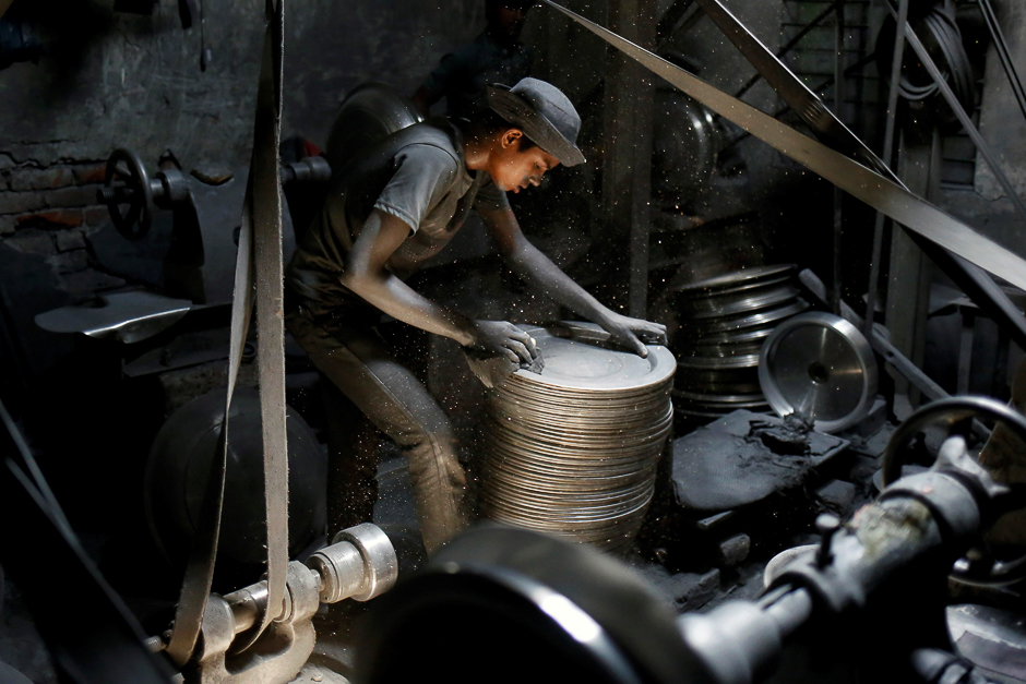 A boy works at a aluminum utensils factory in Dhaka, Bangladesh. PHOTO: REUTERS