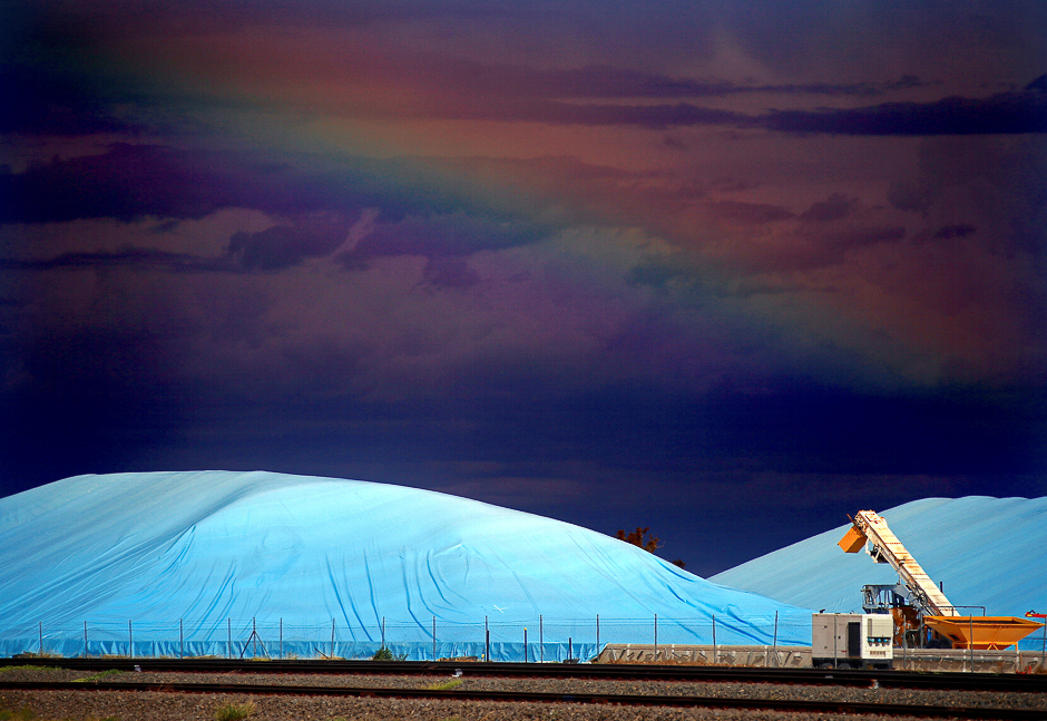 Piles of harvested wheat are covered with plastic sheets near the depot for GrainCorp, Australia's largest listed bulk grain handler, located in the New South Wales town of Burren Junction, located north-west of Sydney in Australia. PHOTO: REUTERS
