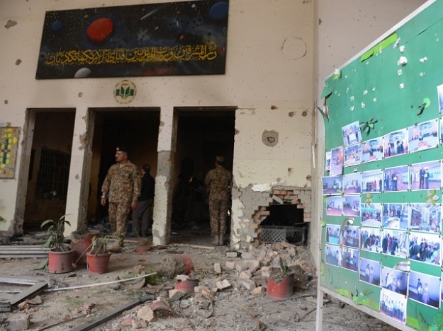 Soldiers walk amidst the debris in an army-run school a day after an attack by Taliban in Peshawar on December 17, 2014. PHOTO: AFP