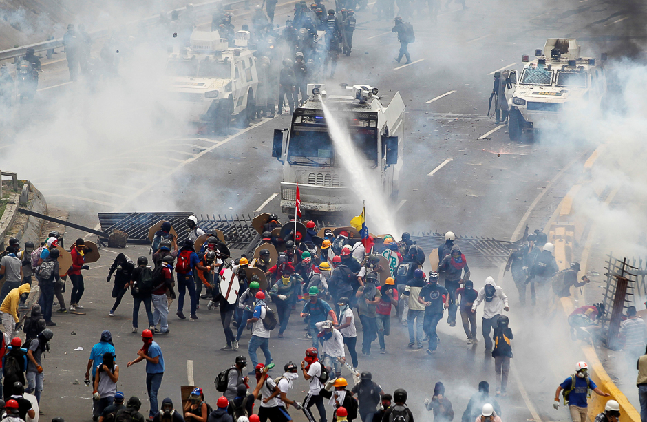 Opposition supporters clash with riot police during a rally against President Nicolas Maduro in Caracas, Venezuela. PHOTO: REUTERS