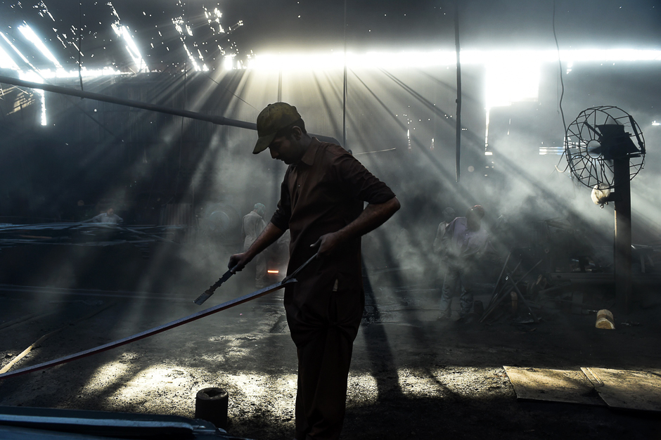 Pakistani labourers work at an iron factory ahead of International Workers' Day in Lahore. PHOTO: AFP