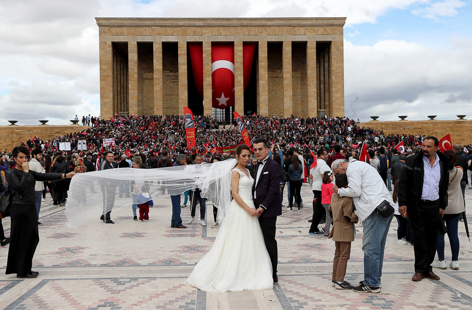 A bridal couple poses for a picture as people gather at Anitkabir, the mausoleum of modern Turkey's founder Mustafa Kemal Ataturk, for the 'Ataturk, Youth and Sports Day' celebrations in Ankara. PHOTO: AFP
