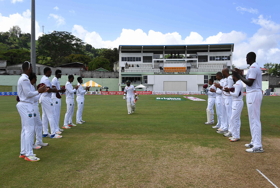 Members of the West Indies team form a guard of honour for captain Misbah-ul-Haq of Pakistan who is playing his final test match, at the Windsor Park Stadium in Roseau, Dominica. PHOTO: AFP