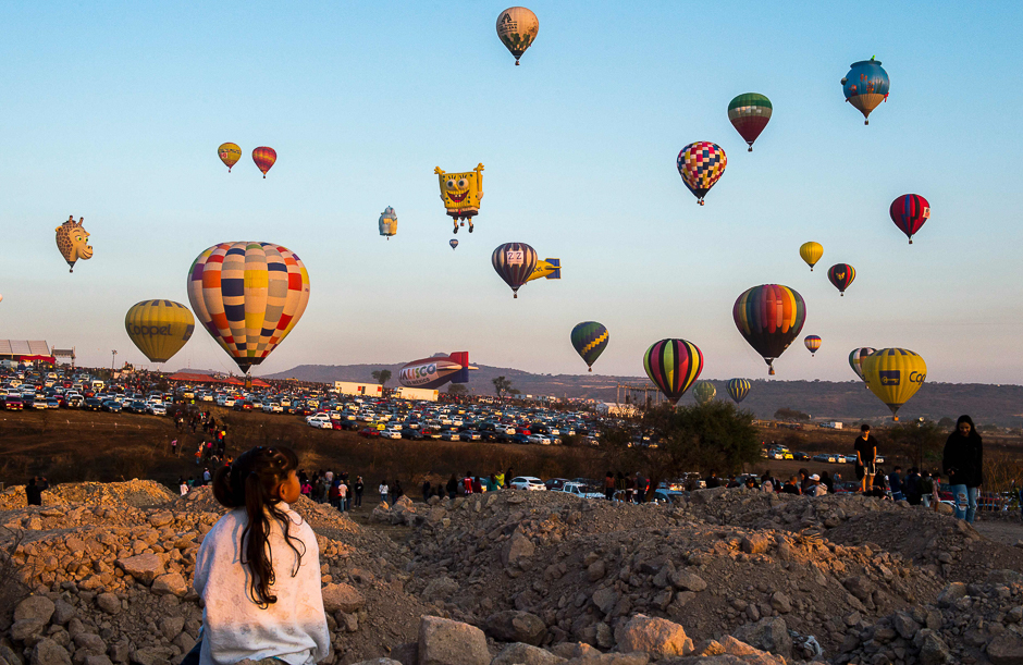 A girl enjoys the hot-air balloons festival in Cajititlan, Jalisco state, Mexico. PHOTO: AFP