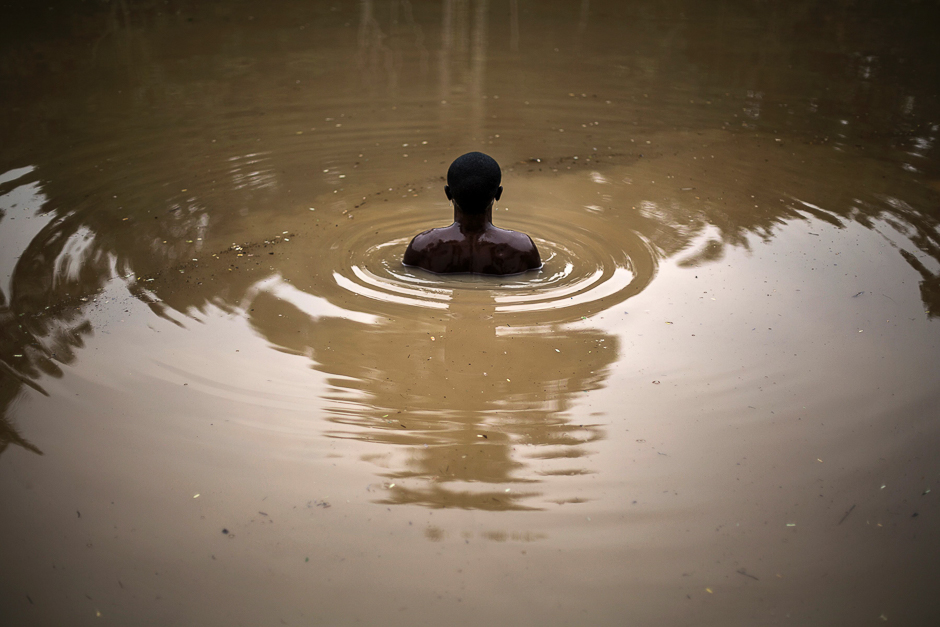 A member of the Kimbanguist church submerges himself three times in the holy water to cleanse himself in Nkamba. PHOTO: AFP