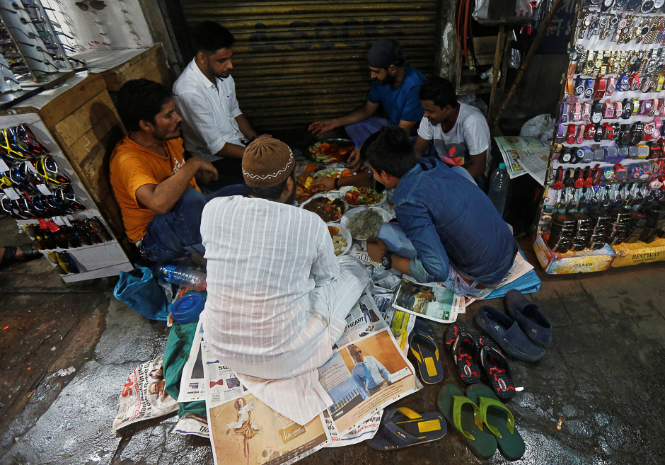 Muslim street vendors eat their iftar (breaking fast) meal on the first day of Ramadan along a roadside in Kolkata, India. PHOTO: REUTERS