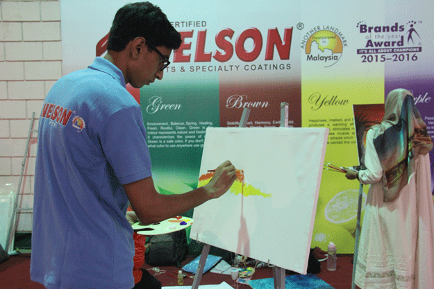A student participates in the painting competition in Hall III. PHOTO: AYESHA MIR