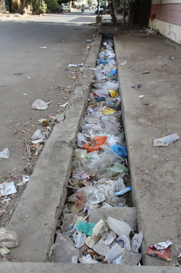 Even the drains are littered with garbage, which will potentially cause flooding in the monsoon season. PHOTO: AYESHA MIR/EXPRESS