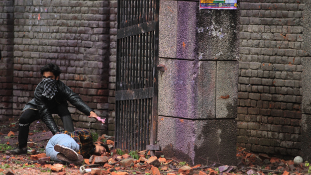 A protester shields a fellow student injured in the clashes in Srinagar. PHOTO: ALJAZEERA
