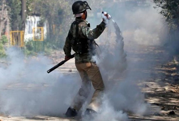 An Indian policeman throws a tear-gas canister during a protest in Srinagar April 17, 2017. PHOTO: REUTERS
