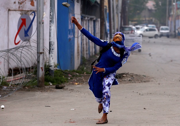 A Kashmiri student throws a stone towards Indian police during a protest in Srinagar. PHOTO: REUTERS