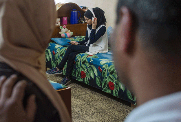 Nour al Ta'i (C), a 15-year-old blind resident of East Mosul and participant in 
