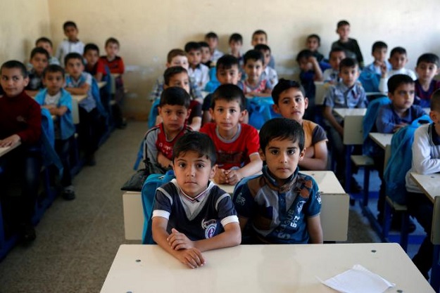 Schoolchildren attend their class at school in eastern Mosul, Iraq. PHOTO: REUTERS
