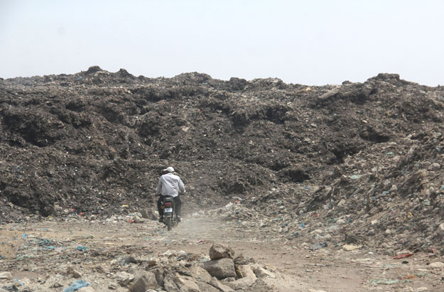 Piles and piles of garbage cover Jam Chakro's 50 acres of land. PHOTO: AYESHA MIR/EXPRESS