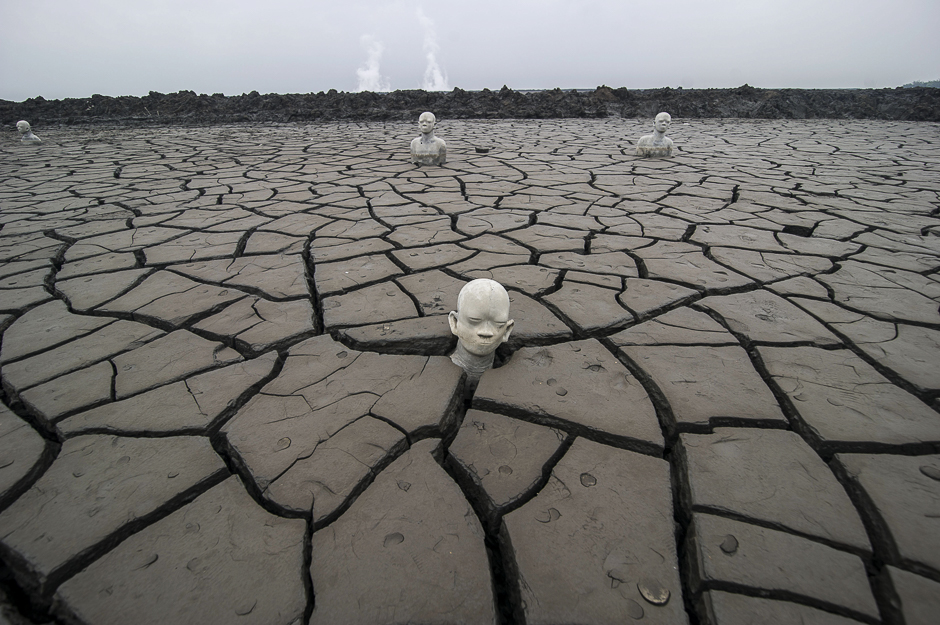 The photo shows statues standing semi-submerged in mud, a symbol of the human toll of the 2006 disaster, at the mud volcano incident area in Sidoarjo, East Java. PHOTO: AFP
