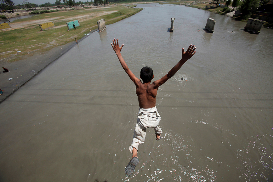 A man jumps into a canal to cool off during a heatwave in Lahore, Pakistan. PHOTO: REUTERS
