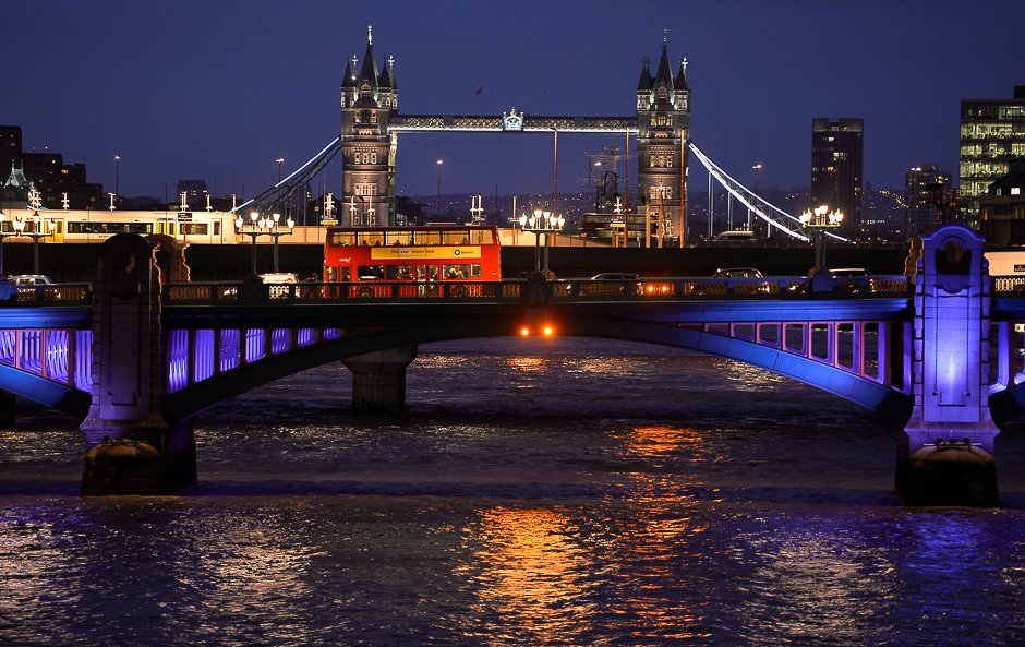 A London bus crosses the River Thames on London Bridge during the evening rush hour with Tower Bridge seen behind in London. PHOTO: REUTERS