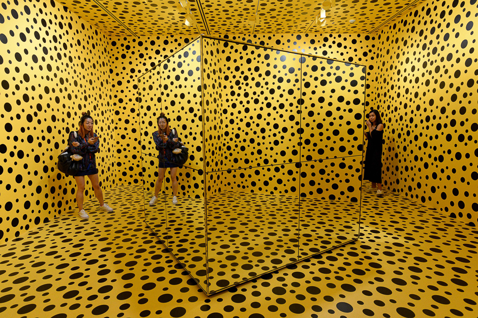 Visitors stand inside an installation by Japanese artist Yayoi Kusuma titled 'The Spirits of the Pumpkins Descended into the Heaven' during a media preview at National Gallery Singapore. PHOTO: AFP