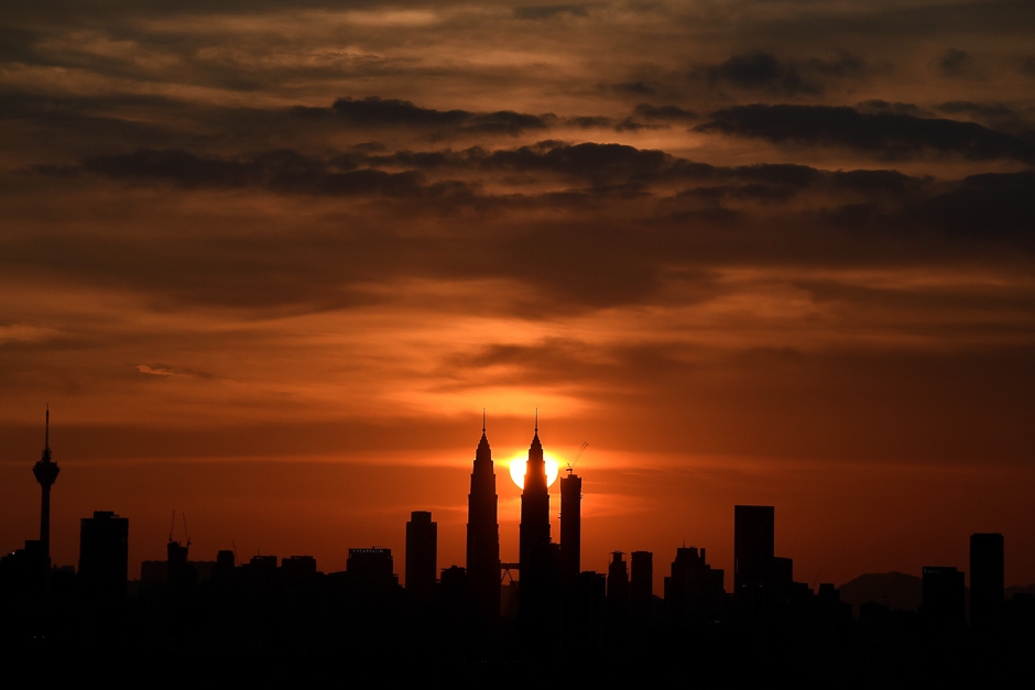 Malaysia's landmark Petronas Twin towers are silhoutted as the sun sets over the Kuala Lumpur skyline. PHOTO: AFP